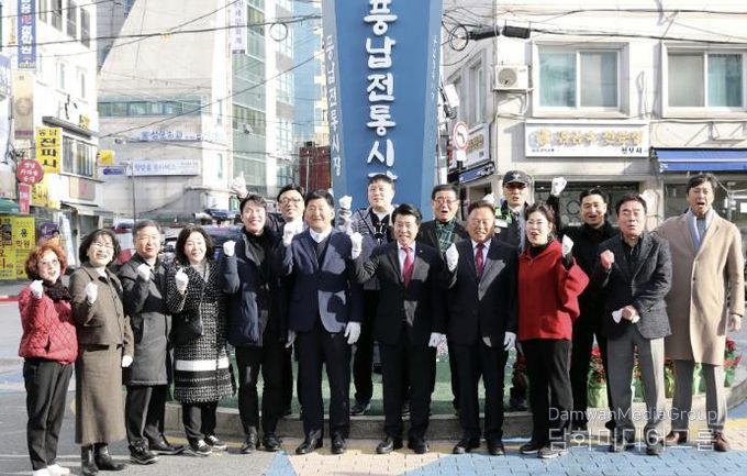 서강석 송파구청장(가운데)이 풍납시장 간판어닝 개선사업 준공현장에 방문해 주민들과 함께 기념촬영을 하고 있다