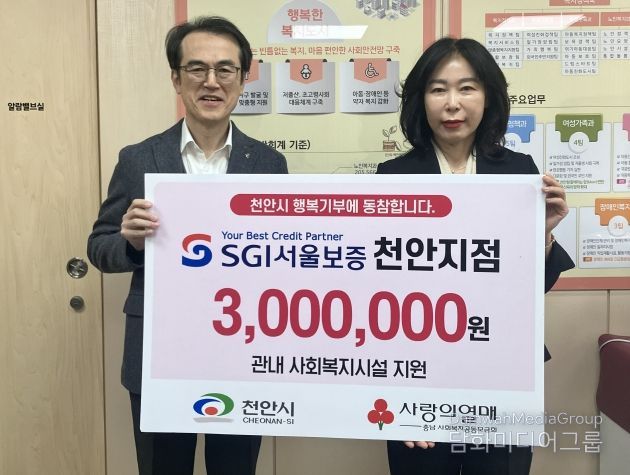 5일 윤은미 천안시 복지정책국장과 이주용 SGI서울보증 천안지점장이 성금 전달식 이후 기념촬영을 하고 있다.